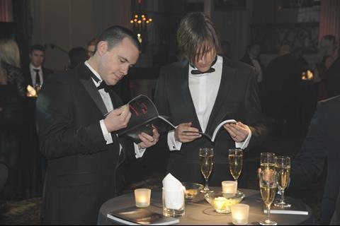 Guests check the programme